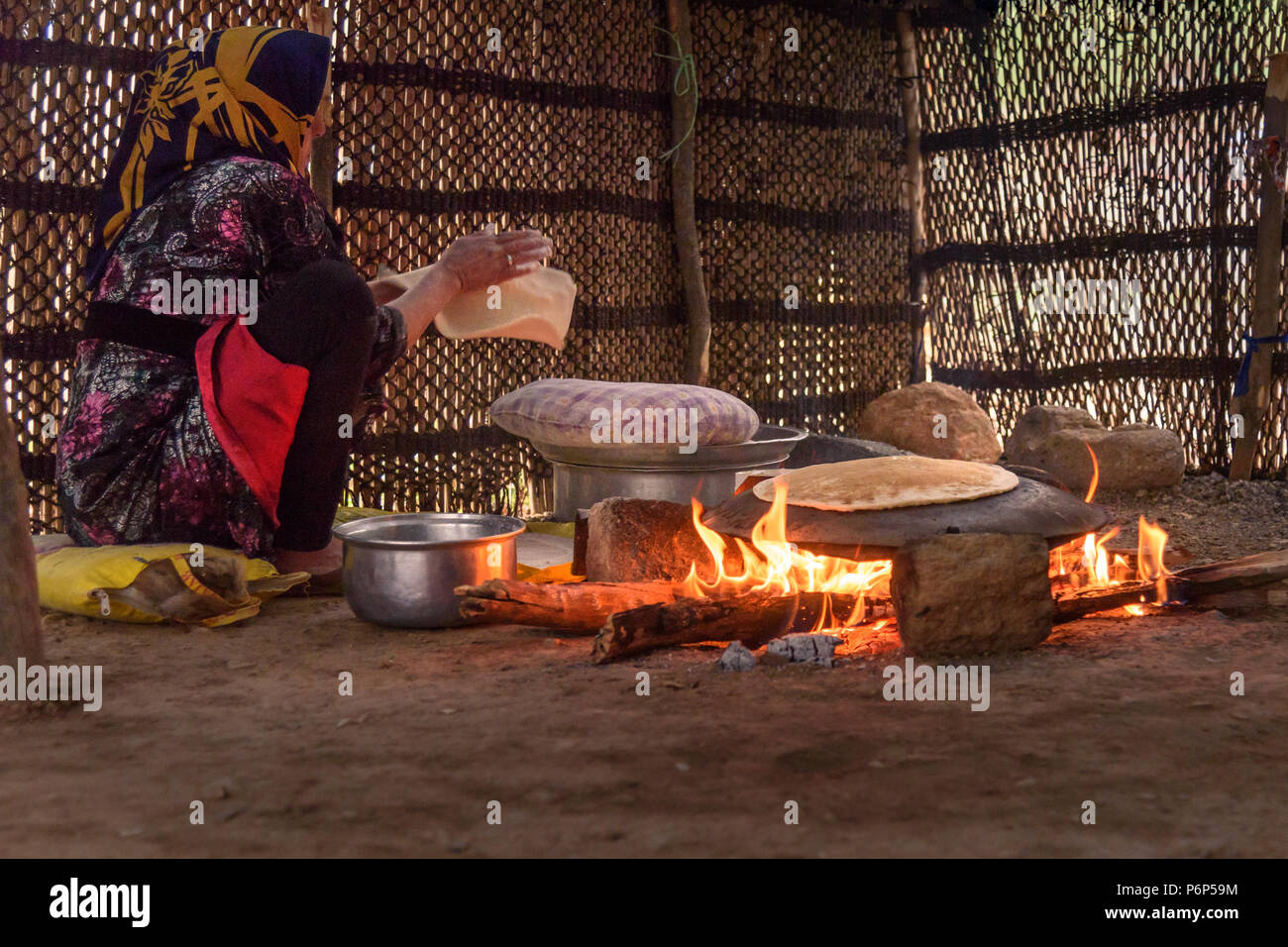 Khorramabad, Lorestan Province, Iran - March 30, 2018: Iranian woman preparing traditional bread on the street market Stock Photo