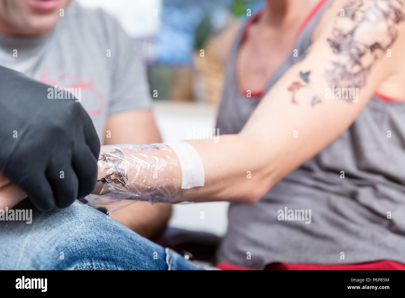 Close-up of the wrapped forearm of a young woman after getting a tattoo Stock Photo