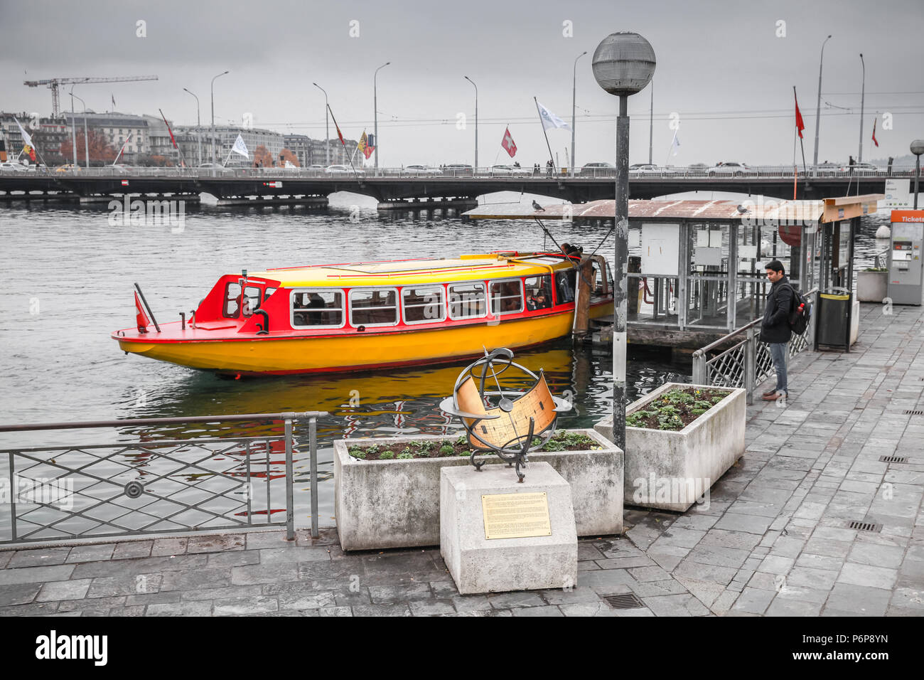 Geneva, Switzerland - November 26, 2016: Passengers loading on boat near bridge Mont-Blanc. One of Mouettes, small yellow water taxis around Geneva la Stock Photo
