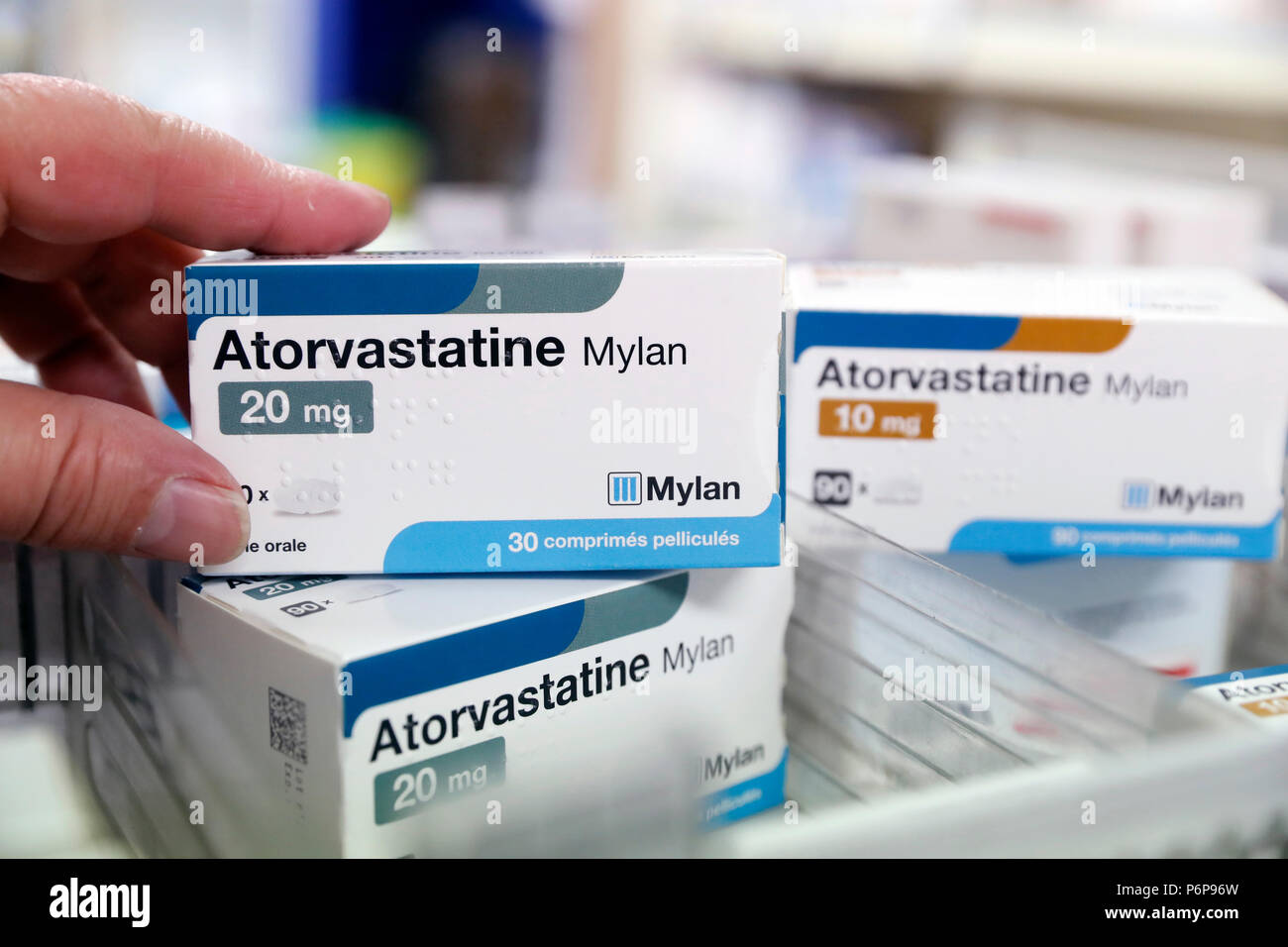 Pharmacy.  Pharmacist taking drug from a drawer cabinet.  Drugs in a sliding drawer.   Atorvastatine.  France. Stock Photo