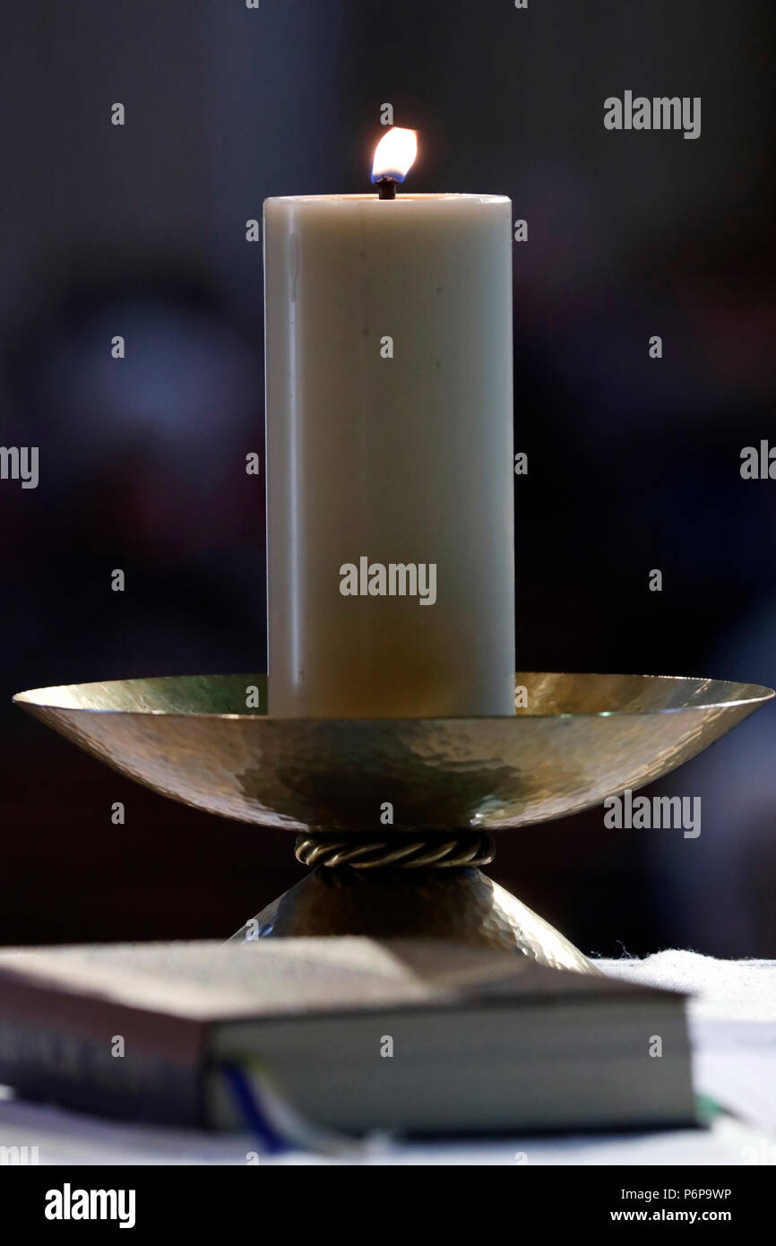 Saint-Jacques church.  Catholic mass.  Church candle and roman missal on an altar.  Sallanches. France. Stock Photo