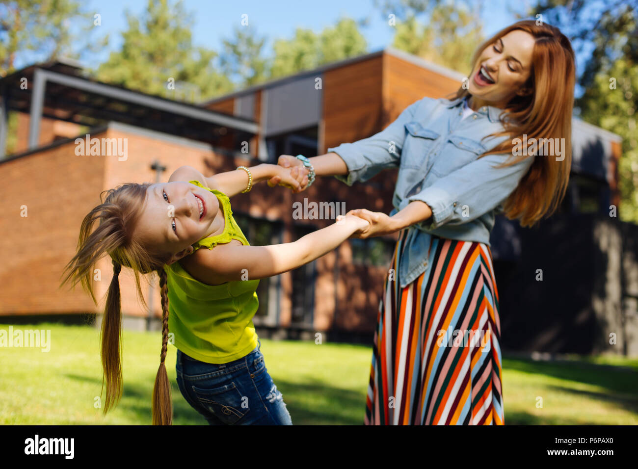 Exuberant girl spending time with her mummy Stock Photo