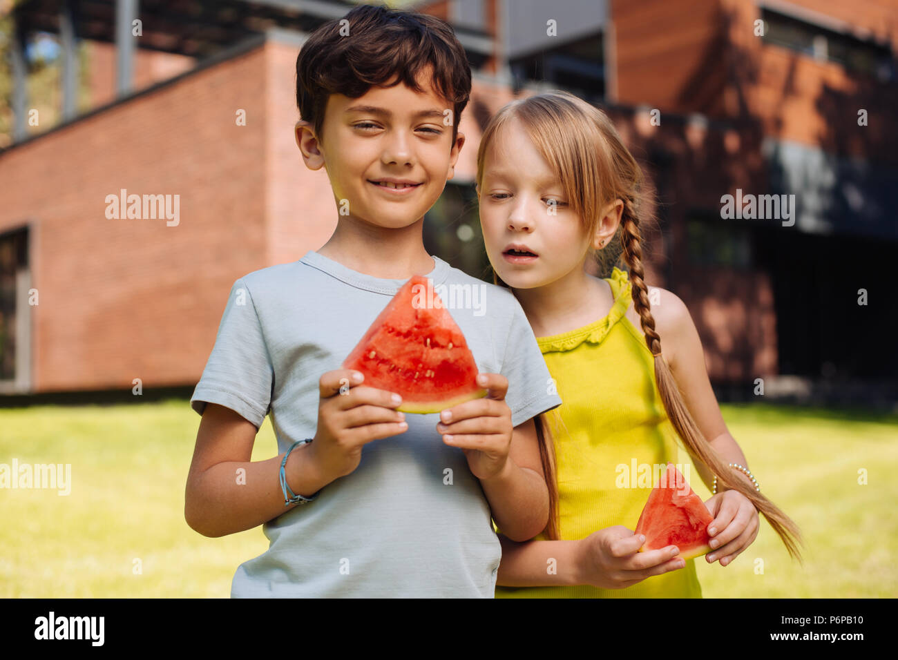 Inspired children eating a ripe watermelon Stock Photo