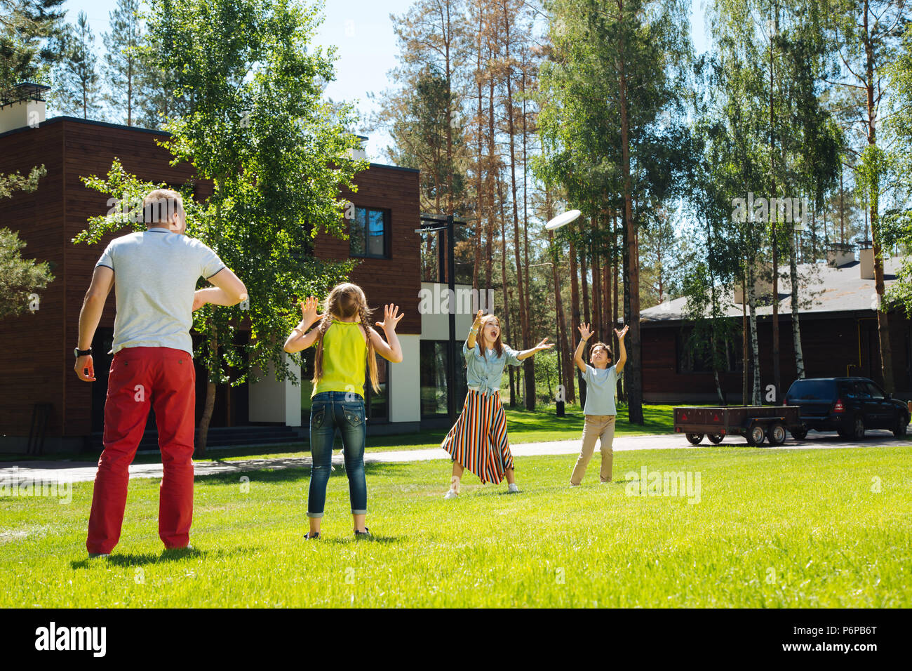 Happy family playing a game in the yard Stock Photo - Alamy