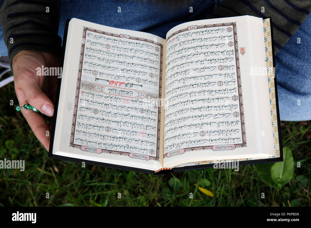 Young man reading the Kuran. France. Stock Photo