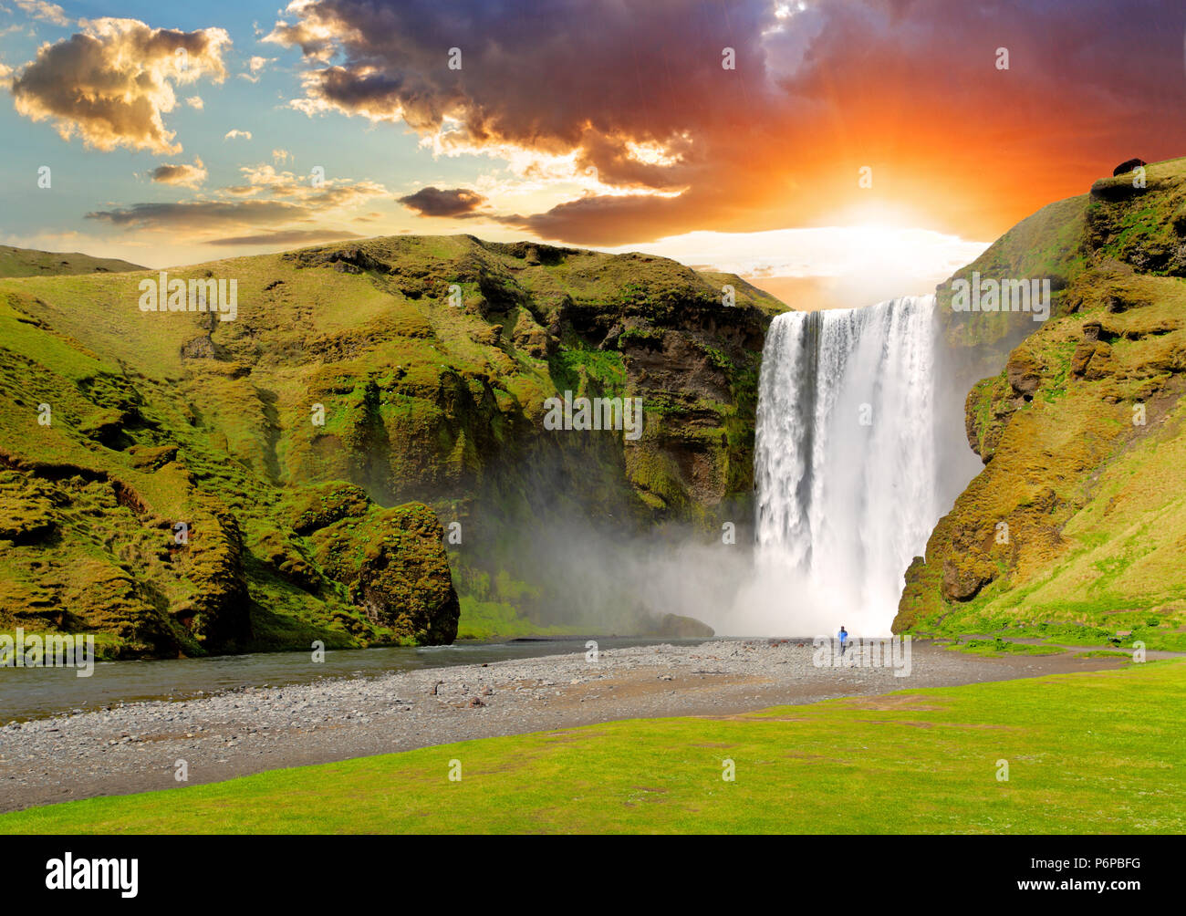 famous waterfall Skogafoss in Iceland at sunset Stock Photo