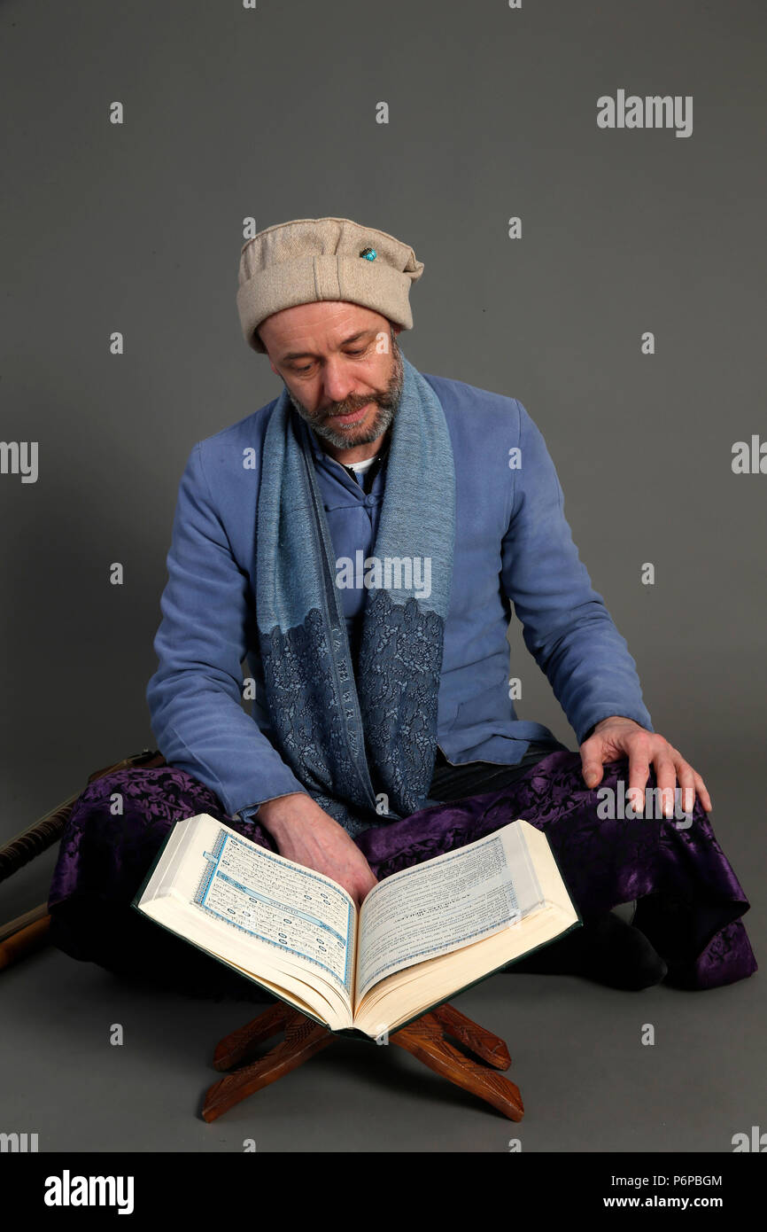 Muslim reading Kuran. Paris, France. Stock Photo