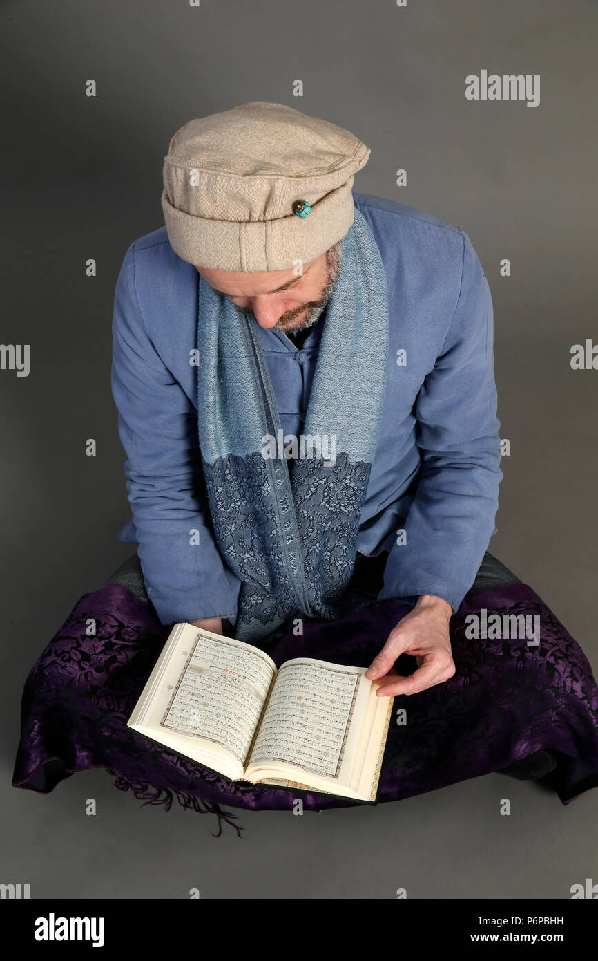 Muslim reading Kuran. Paris, France. Stock Photo