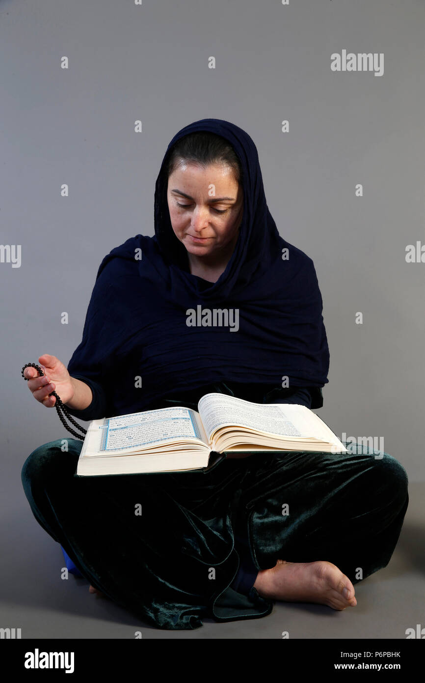 Woman reading Kuran. Paris, France. Stock Photo