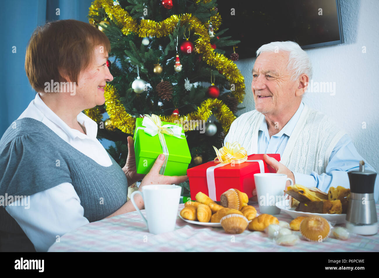 Mature woman wrapping christmas gift hi-res stock photography and ...