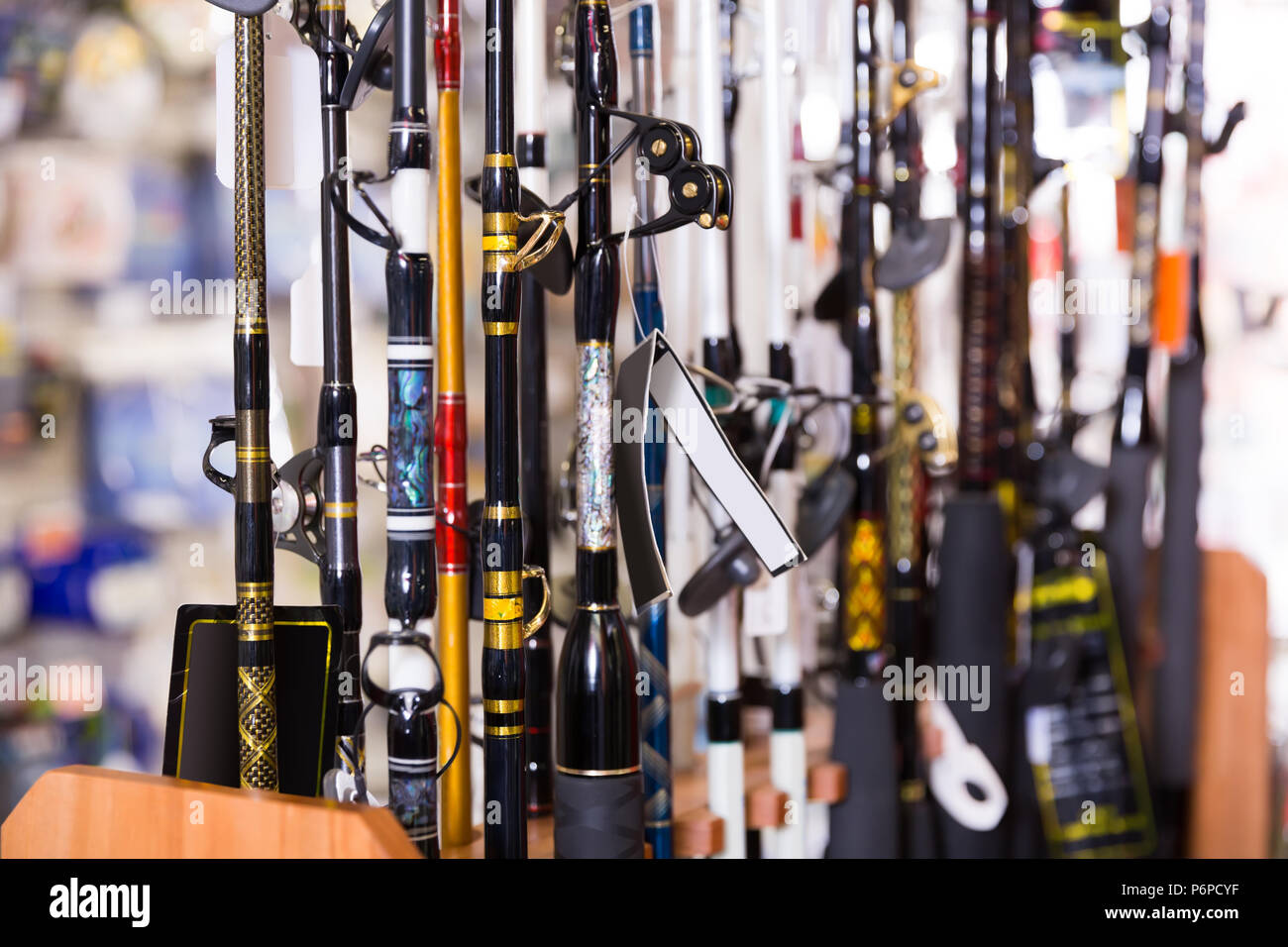 stand with diverse fishing rods in the sports shop indoor Stock Photo ...