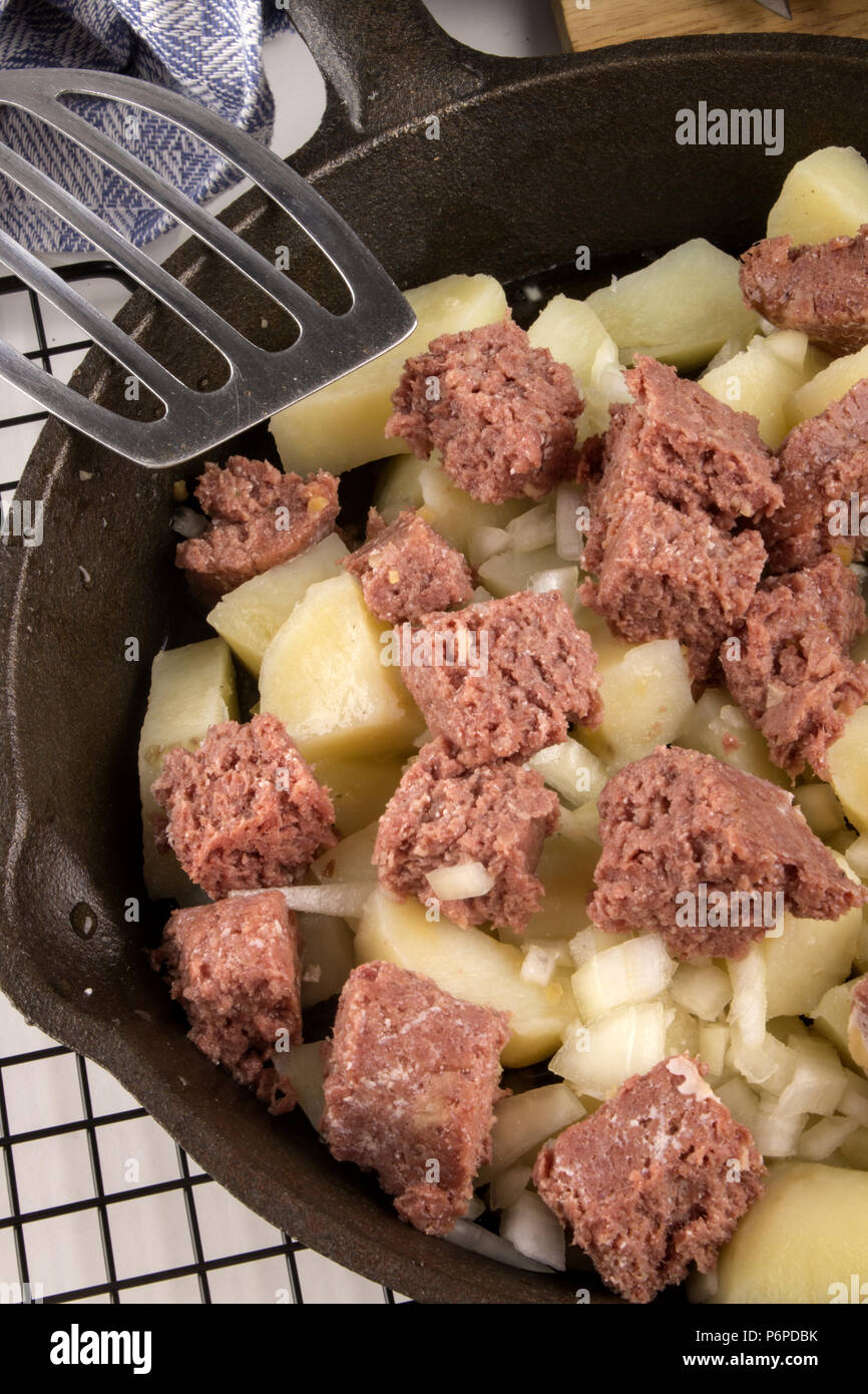 very irish meal, raw corned beef hash in a cast iron pan Stock Photo