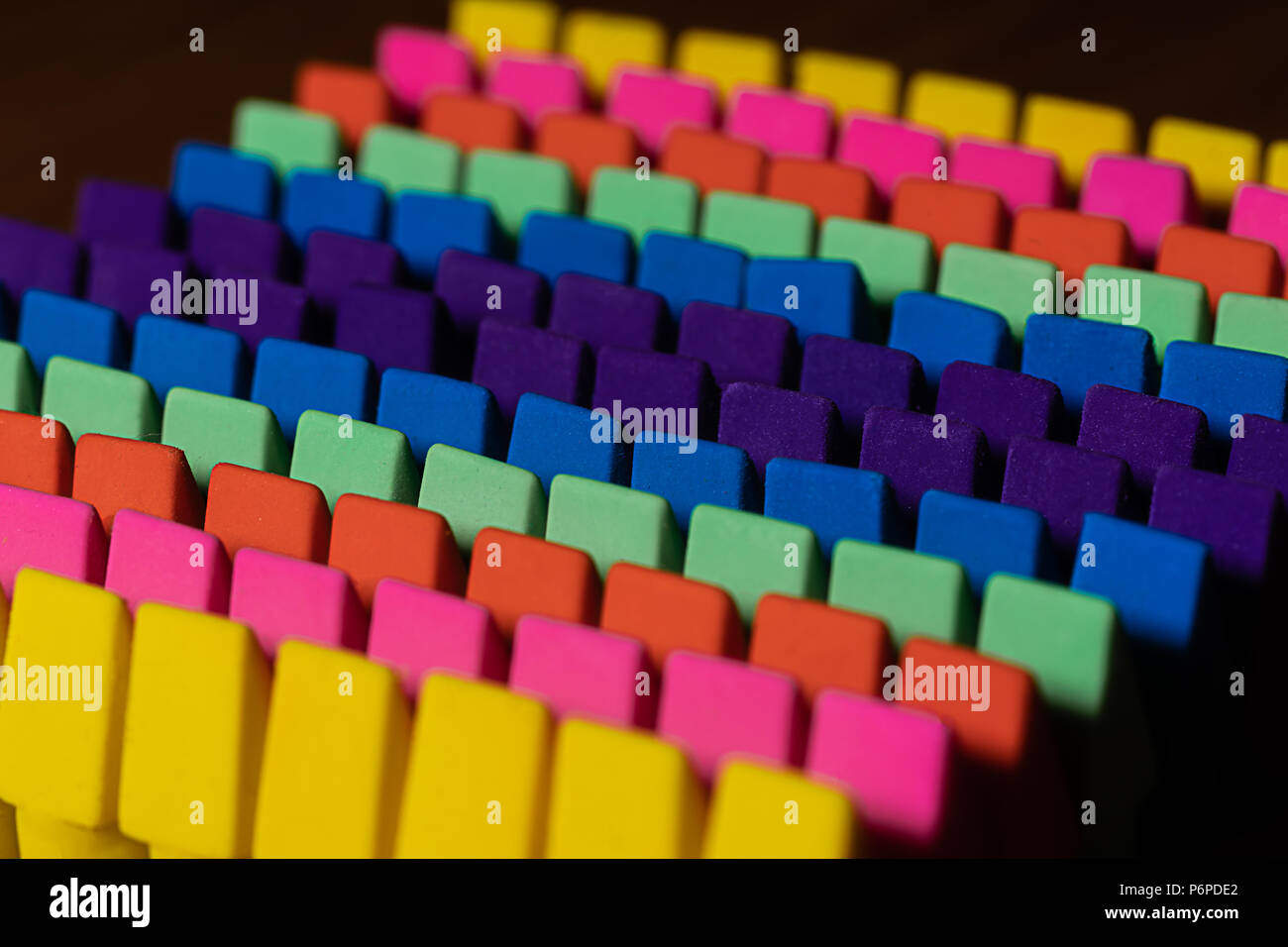 Rows of brightly colored pencil erasers lined up in an OCD orderly fashion with a high contrast