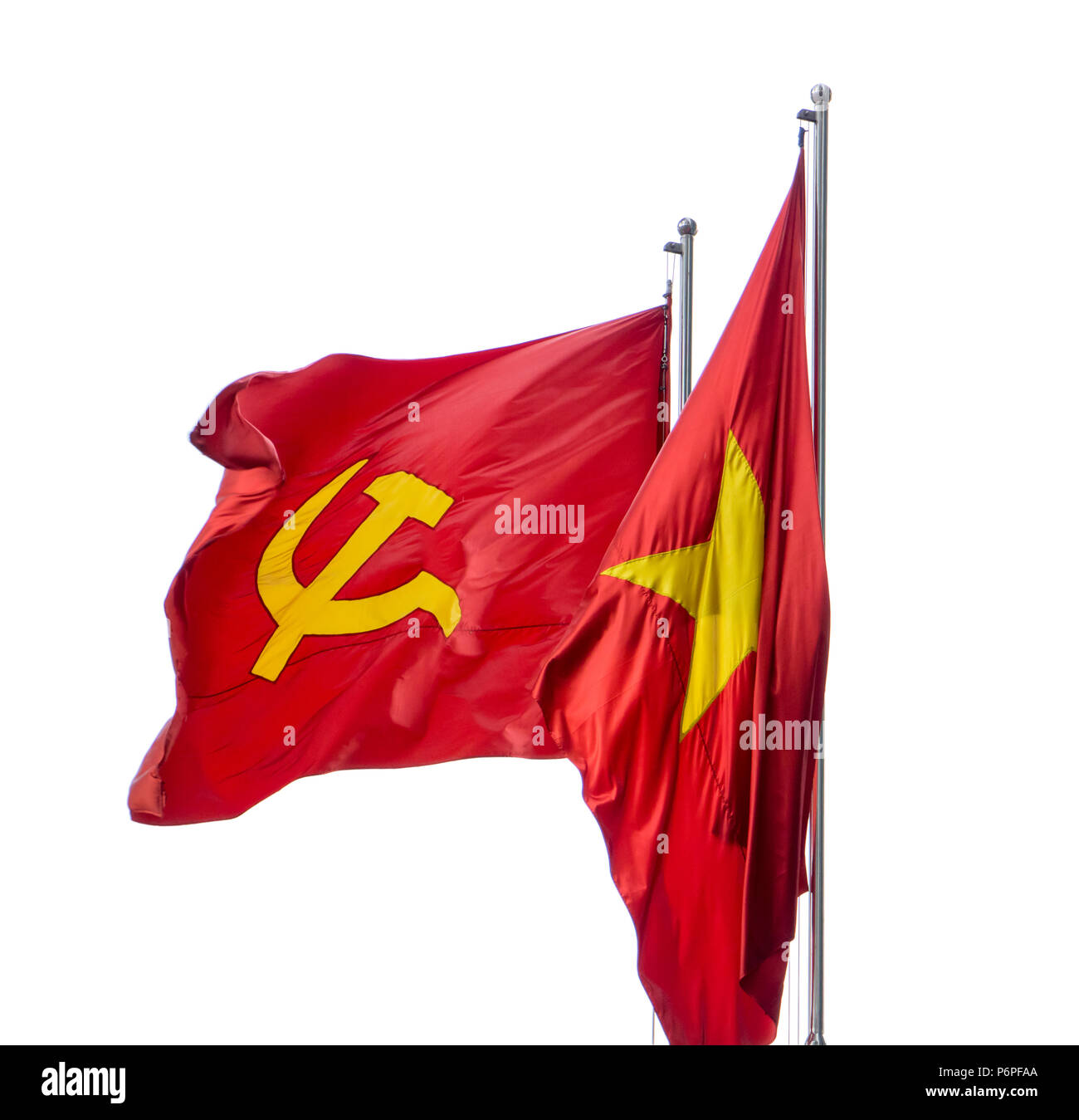 The red flag with communist symbols of a sickle and a hamme.The Red flag with a five-pointed star flutters on the pole. Stock Photo