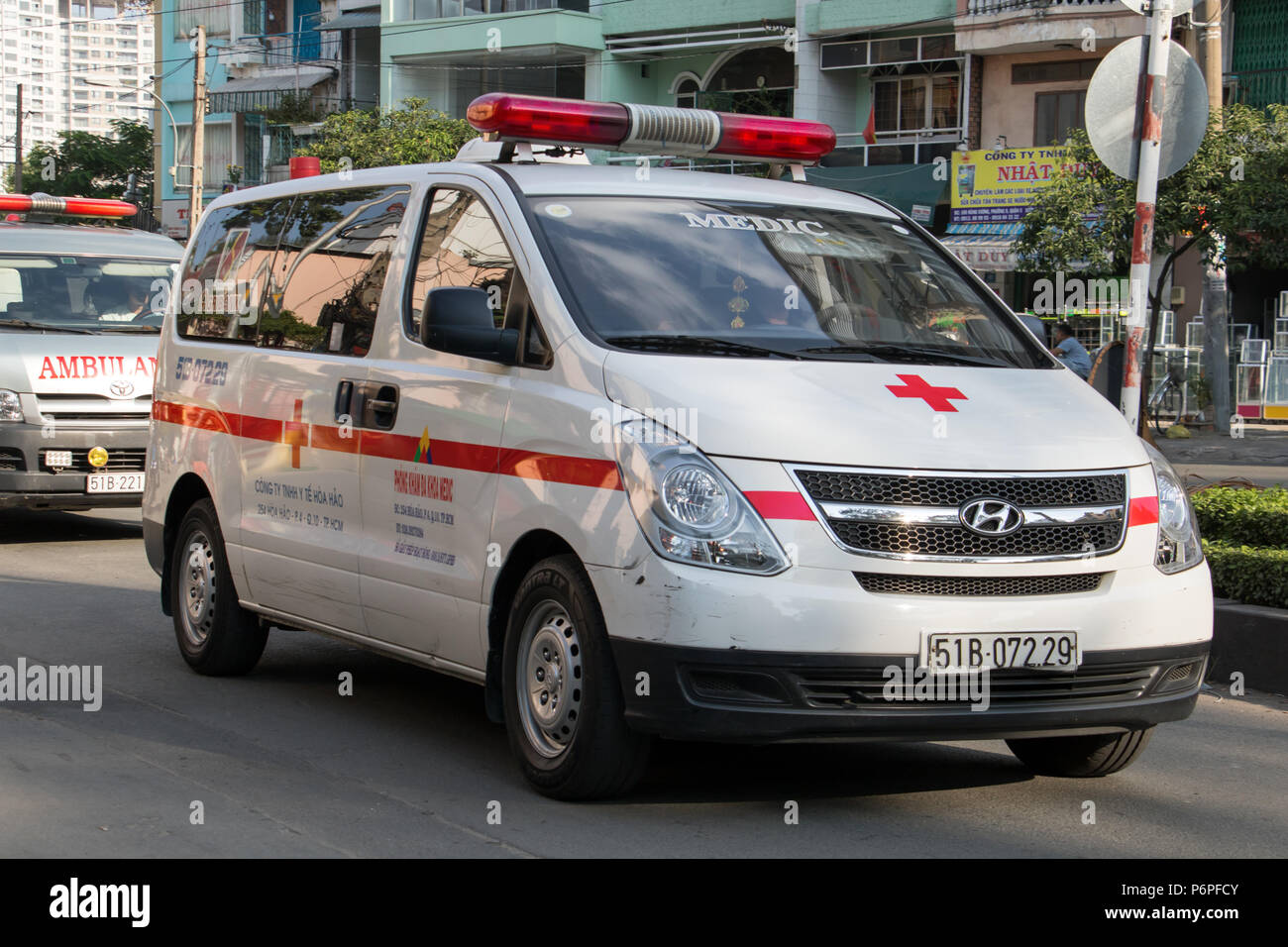 SAIGON, VIETNAM, DEC 18 2017, Ambulance cars are driving at the street. The rescue car in Saigon. Stock Photo