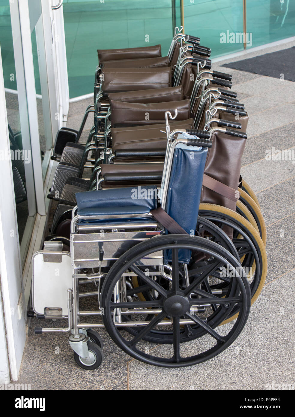 The wheelchairs are in a row at the entrance to the hospital Stock