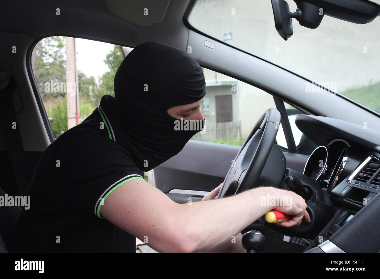 Car Thief Trying To Break Into A Car With A Screwdriver Stock Photo Alamy