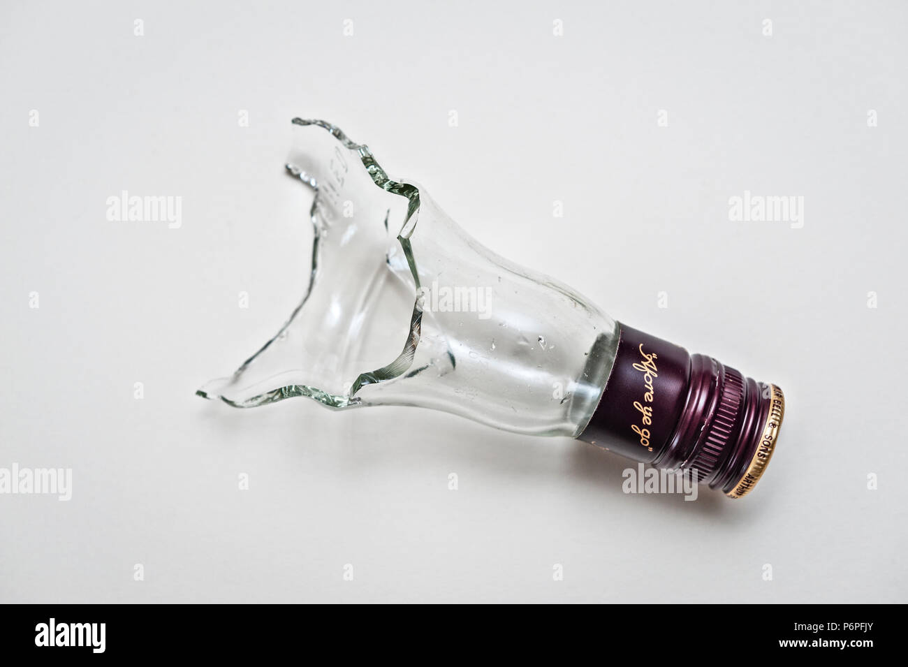The neck of a broken whisky bottle makes a vicious weapon in hand to hand fighting, such as a bar brawl Stock Photo
