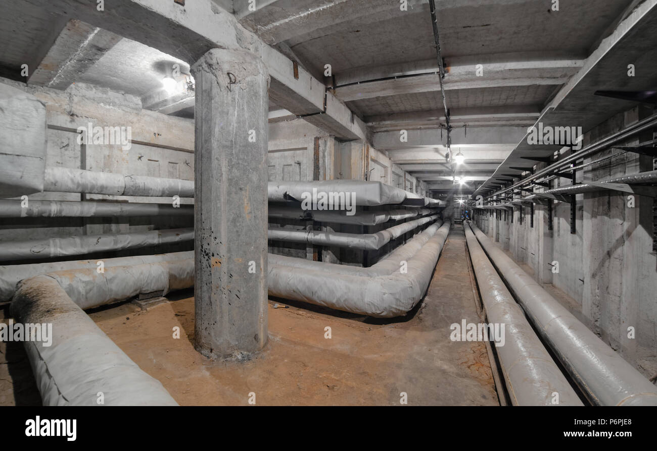 Special bending of the heating main pipe in underground concrete utility tunnel network of water supply pipeline, heat pipeline and cable vault Stock Photo
