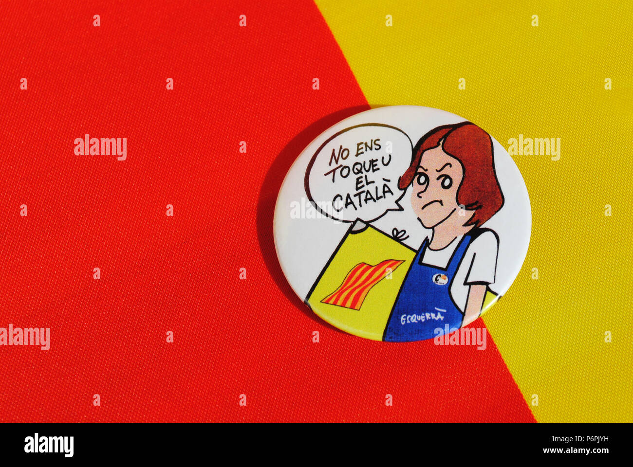 A circular badge on red and yellow background depicting a cartoon female student who disagrees with Spain's planned language system in education. Stock Photo