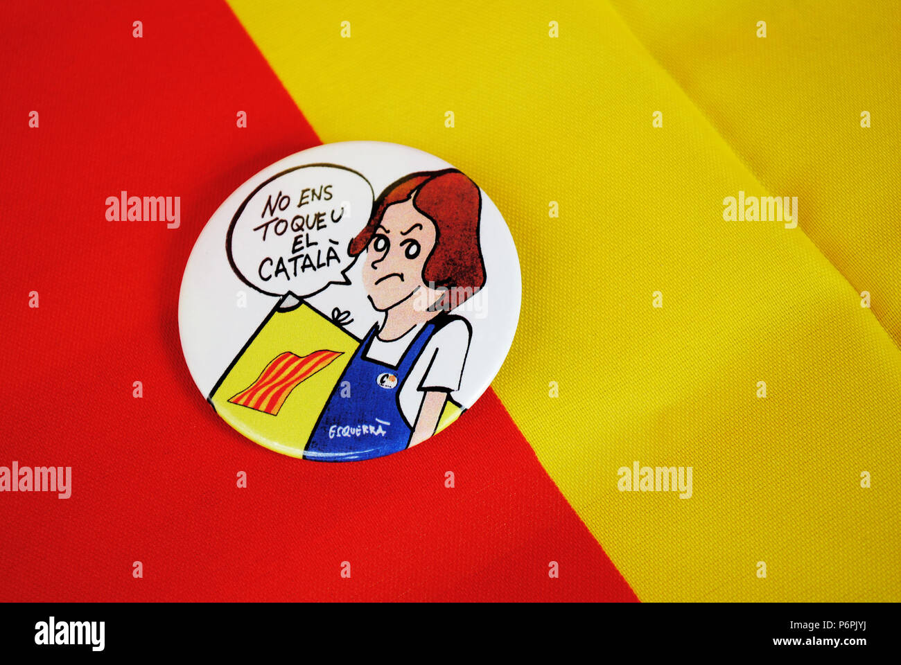 A circular badge on red and yellow background depicting a cartoon female student who disagrees with Spain's planned language system in education. Stock Photo