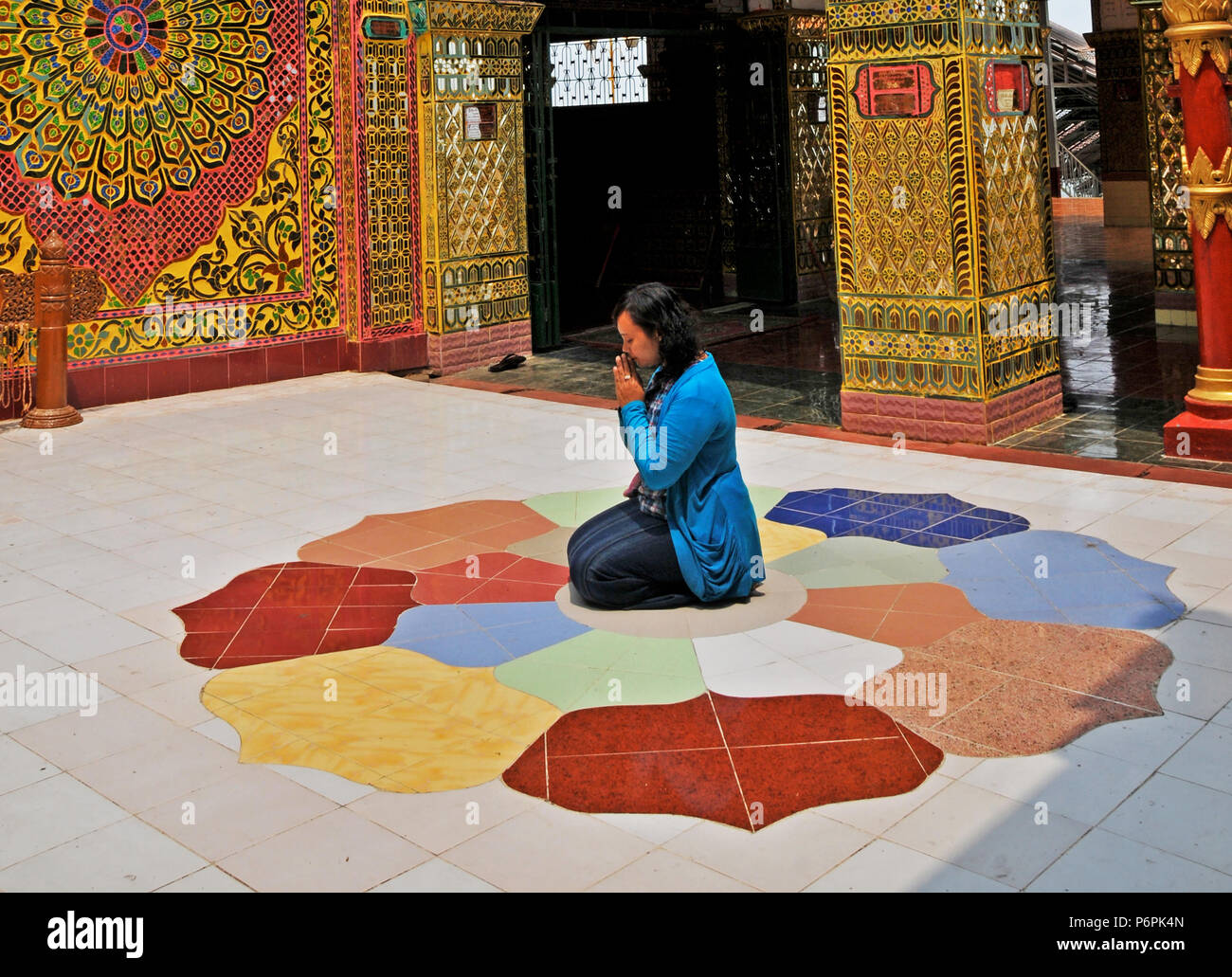 woman praying, Pyi Su Taung temple, Mandalay hill , Myanmar Stock Photo