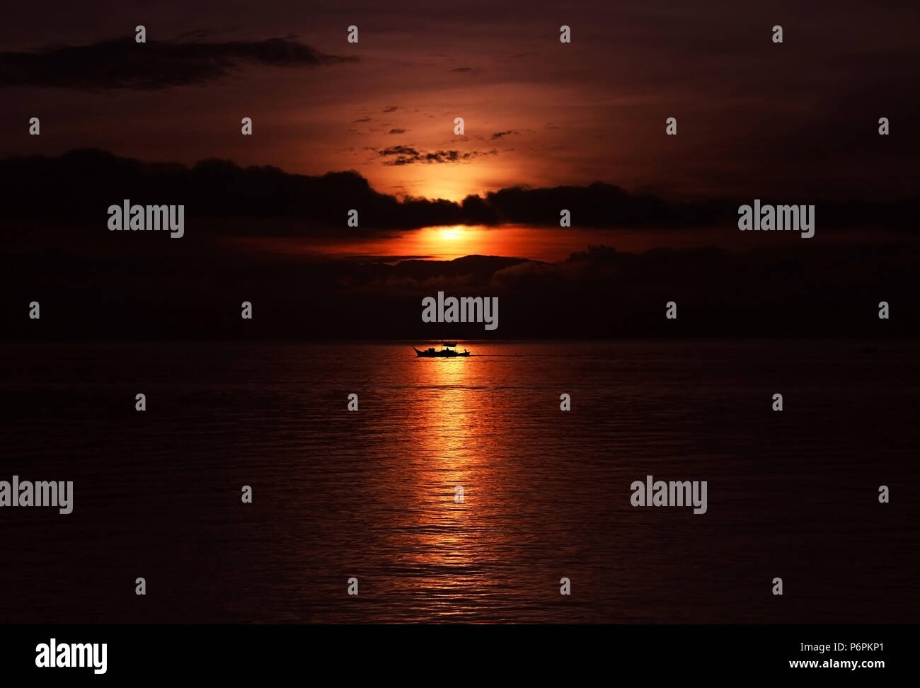 Dramatic Sun Rising at the Beach with silhouette of boat Stock Photo ...