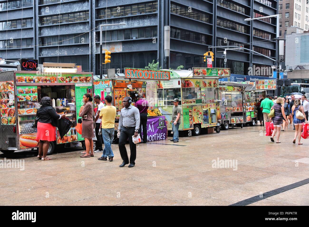 NEW YORK - JULY 2: People visit food trucks in Lower Manhattan on July 2, 2013 in New York. Almost 19 million people live in New York City metropolita Stock Photo