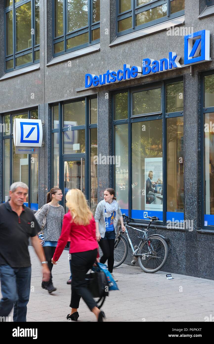 HAMBURG, GERMANY - AUGUST 28, 2014: People walk by Deutsche Bank branch in Hamburg. Deutsche Bank is one of largest banks in the world with 98,200 emp Stock Photo