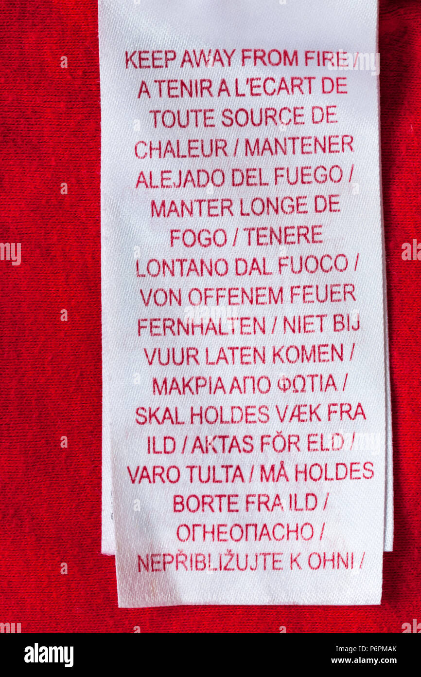 Keep away from fire label in many different languages in clothing translated in many different languages multi-languages various lots languages Stock Photo
