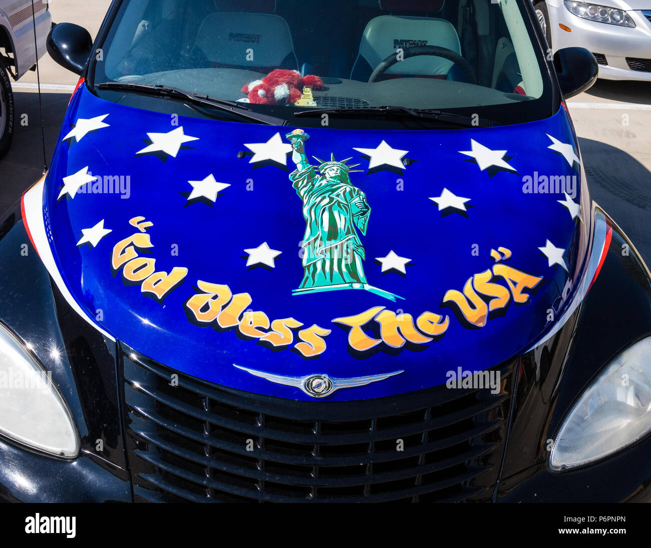 Show your colors, a car owner in Texas painted how he felt on the hood of his car. An American car. 'God Bless the USA' Stock Photo