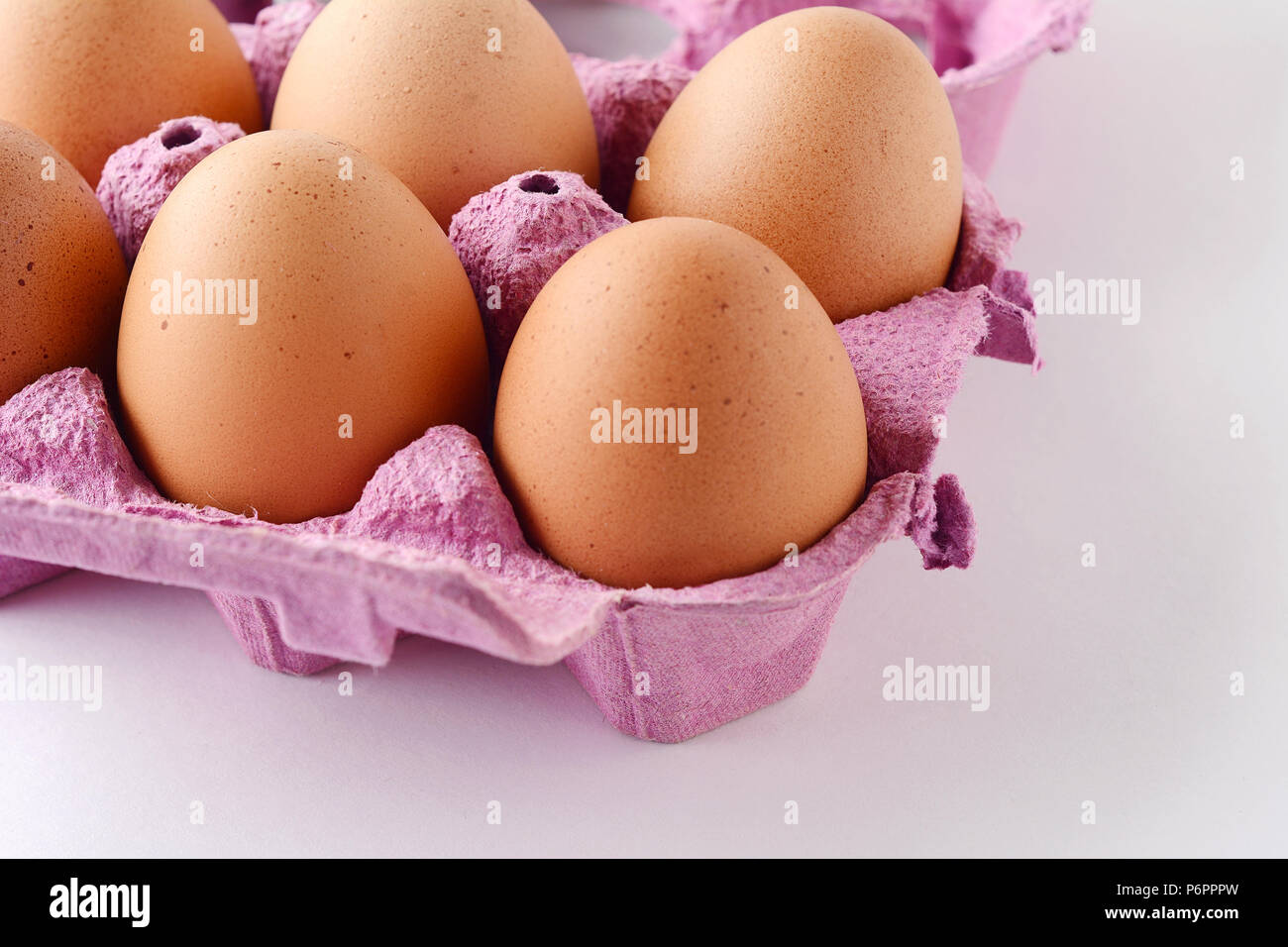 Top view of six brown eggs on box. Fresh food concept. White background Stock Photo