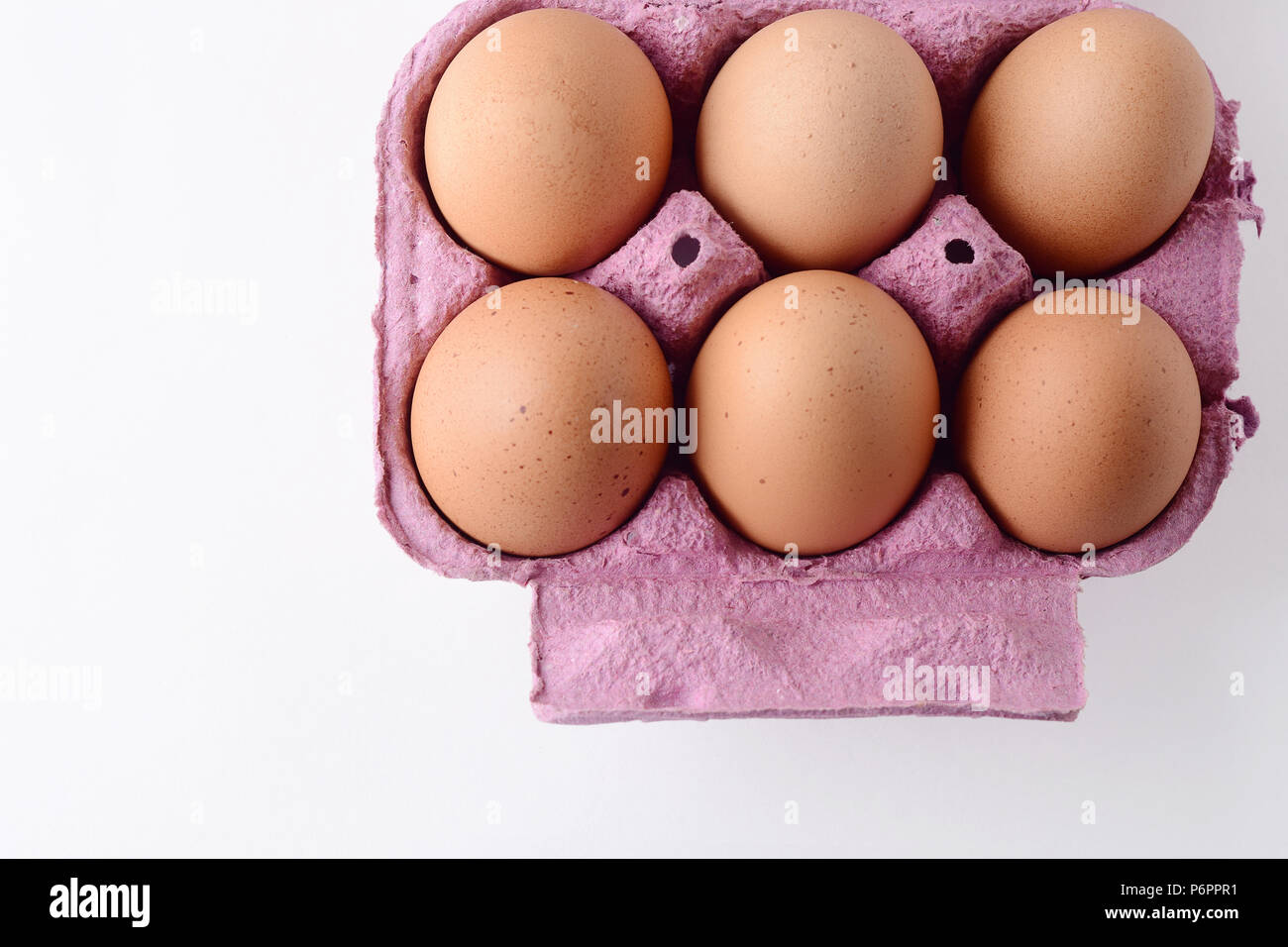 Top view of six brown eggs on box. Fresh food concept. White background Stock Photo