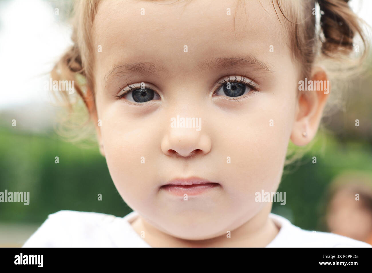 Close up Portrait of cute baby girl in the park Stock Photo - Alamy