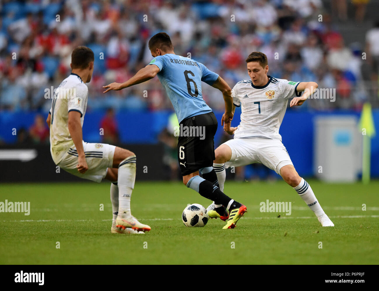 Samara, Russia - June 25, 2018. Russian players Roman Zobnin and Daler Kuzyaev against  Uruguayan midfielder Rodrigo Bentancur during FIFA World Cup 2 Stock Photo