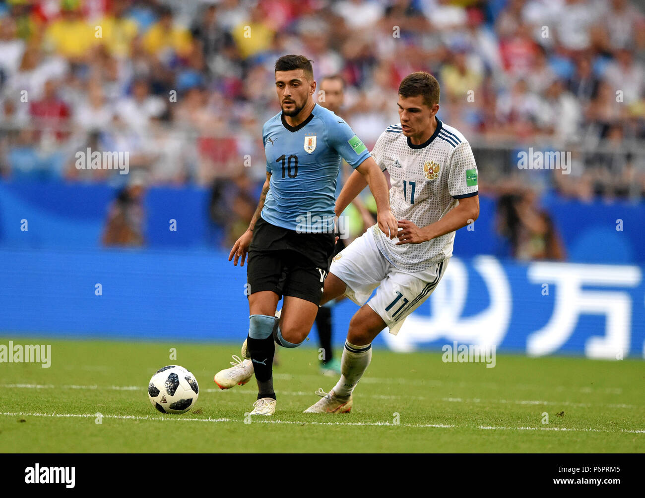 Samara, Russia - June 25, 2018. Uruguayan striker Giorgian De Arrascaeta and Russian midfielder Roman Zobnin during FIFA World Cup 2018 match Uruguay  Stock Photo