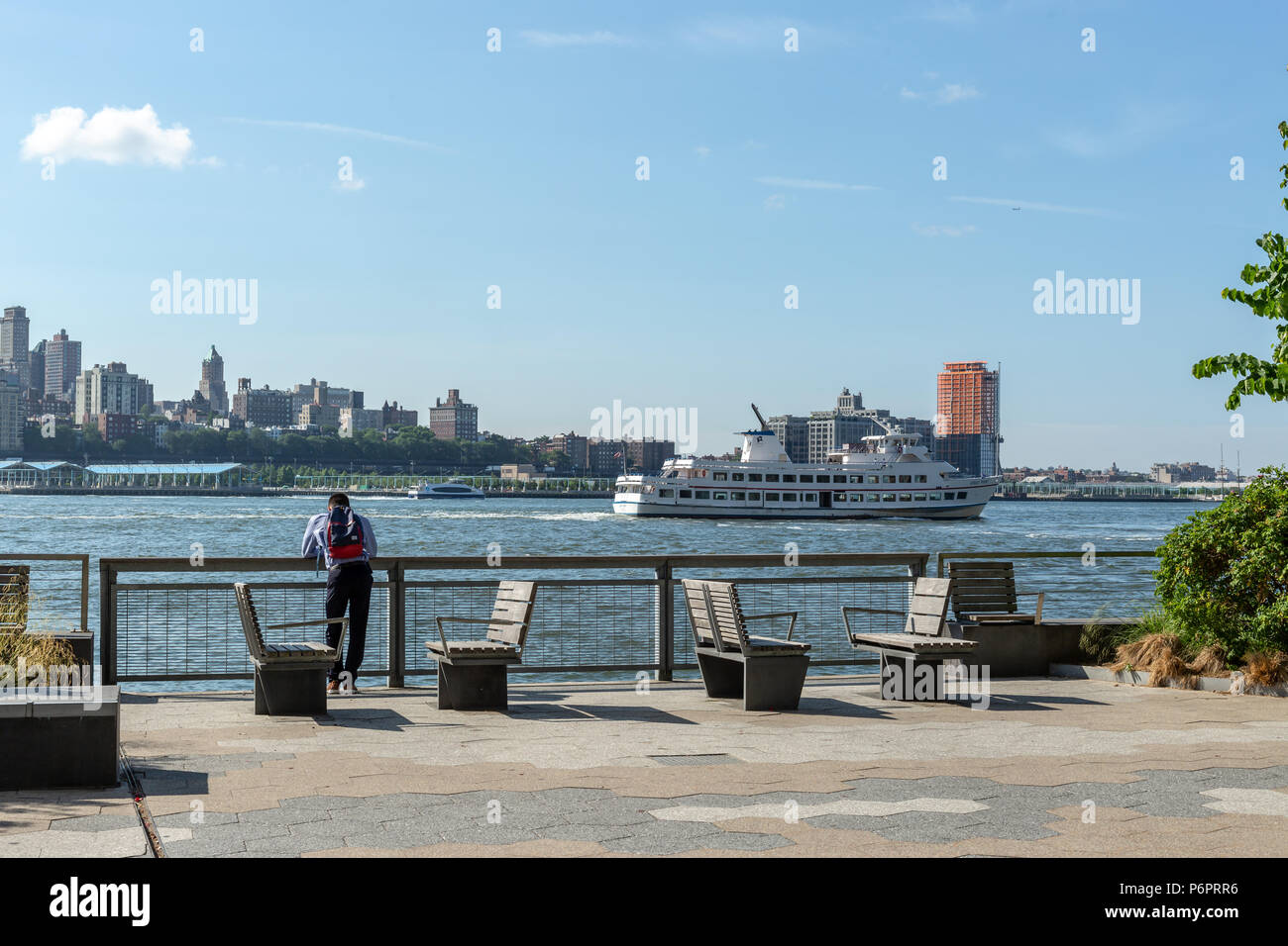 New York City / USA - JUN 25 2018: A man standing on Pier 15 at early morning Stock Photo