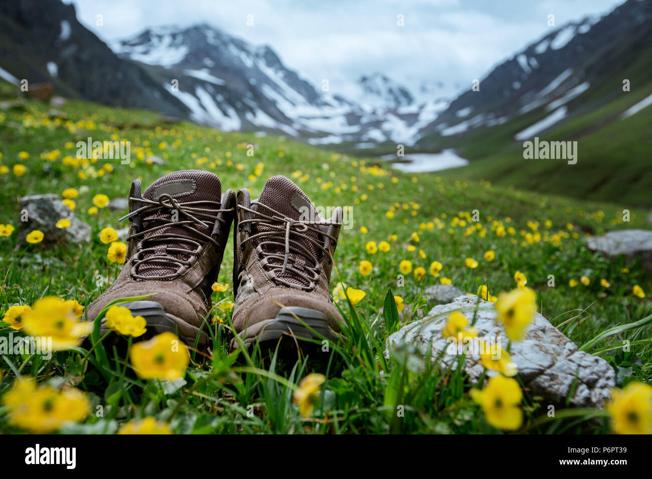 Pair of hiking boots lying in the grass Stock Photo