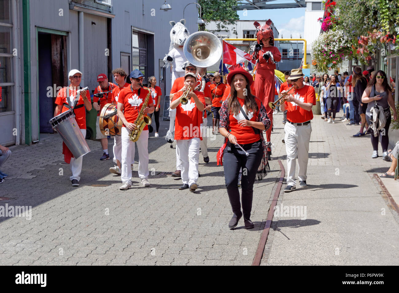 A marching band leads the annual Canada Day Parade on Granville Island