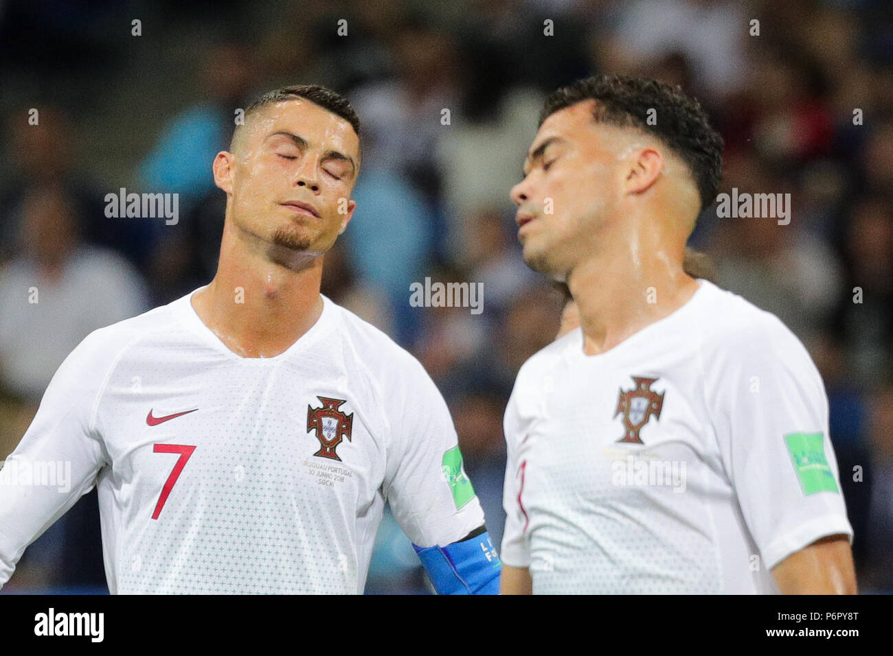 Sochi, Russia. 30th June, 2018. Soccer, World Cup 2018, Round of 16, Uruguay vs. Portugal at the Sochi stadium. Portugal's Cristiano Ronaldo and Pepe (R) reacting on the pitch. Credit: Christian Charisius/dpa/Alamy Live News Stock Photo