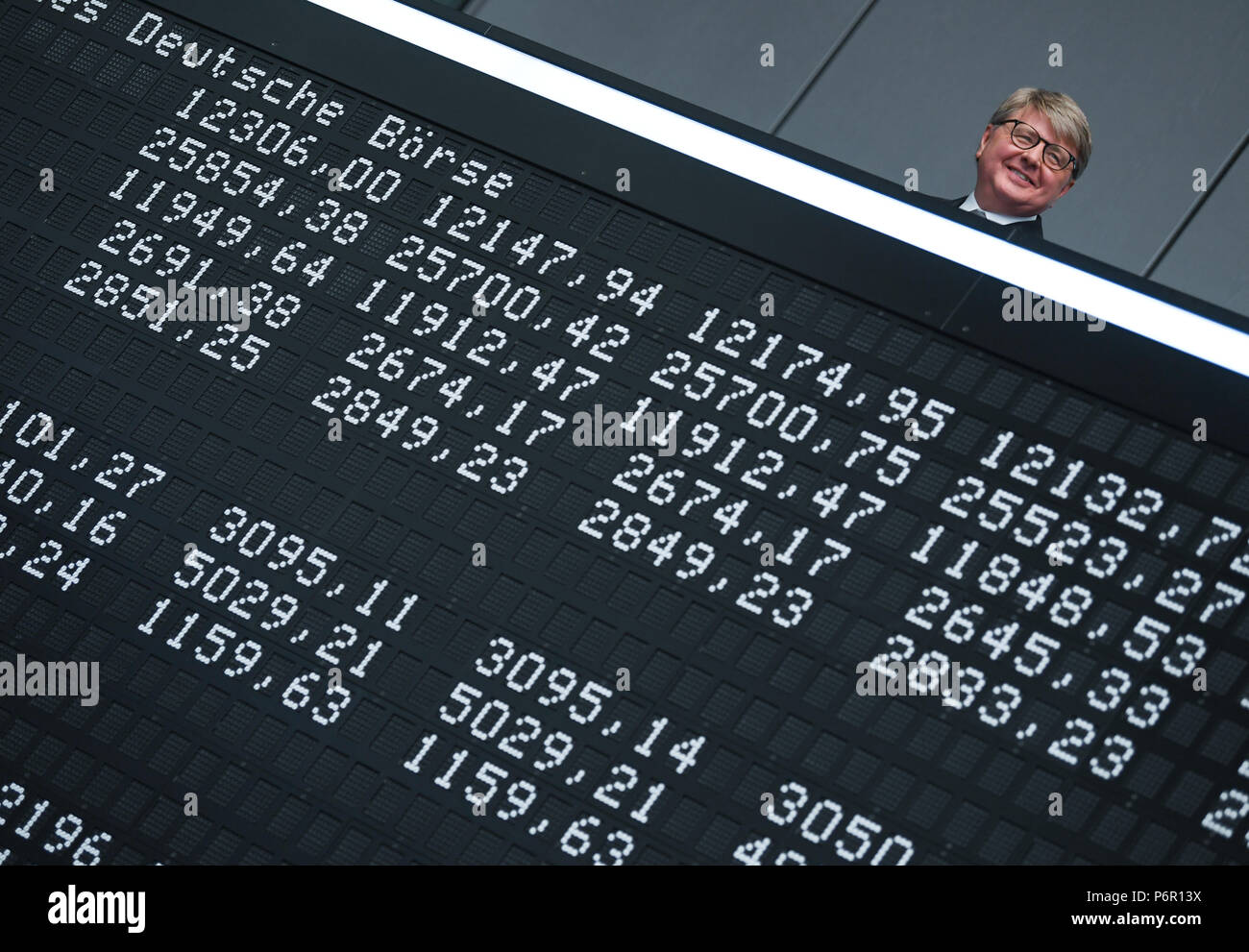 Frankfurt, Germany. 02nd July, 2018. Chairman of the Deutsche Boerse AG, Theodor Weimer (L-R), Frank Mella, standing over a display board with the indexes of the German stock exchange for the 30 year anniversary of the DAX. Thirty years after its introduction, the German lead index is one of the most significant market indicators in the world and, despite a few set backs, a success story. Since the first trading day on the 1 July 1988 with 1163 points, the German stock index has strongly increased, at times by more than 13,000 points. Credit: Arne Dedert/dpa/Alamy Live News Stock Photo