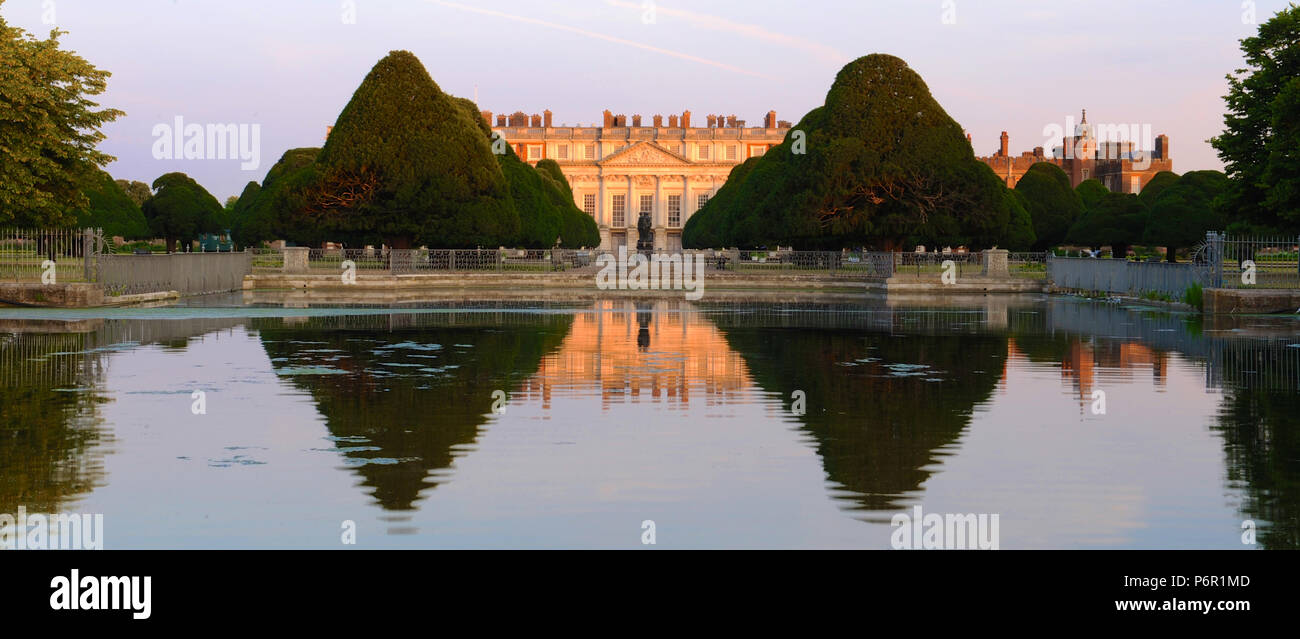 London, UK. 2nd July 2018. Hampton Court Palace at dawn on the opening day of the 2018 RHS Hampton Court Flower Show which opened today - London, United Kingdom - 02 July 2018  Held since 1913, the five day event is the most prestigious flower and garden show in the United Kingdom and the world’s largest annual flower show boasting an eclectic mix of gardens and displays over 34 acres either side of the dramatic long water. It attracts around 168,000 visitors each year.  There are 14 show gardens and 11 other themed gardens on display at this year’s show as well as over 93 plant displays in th Stock Photo