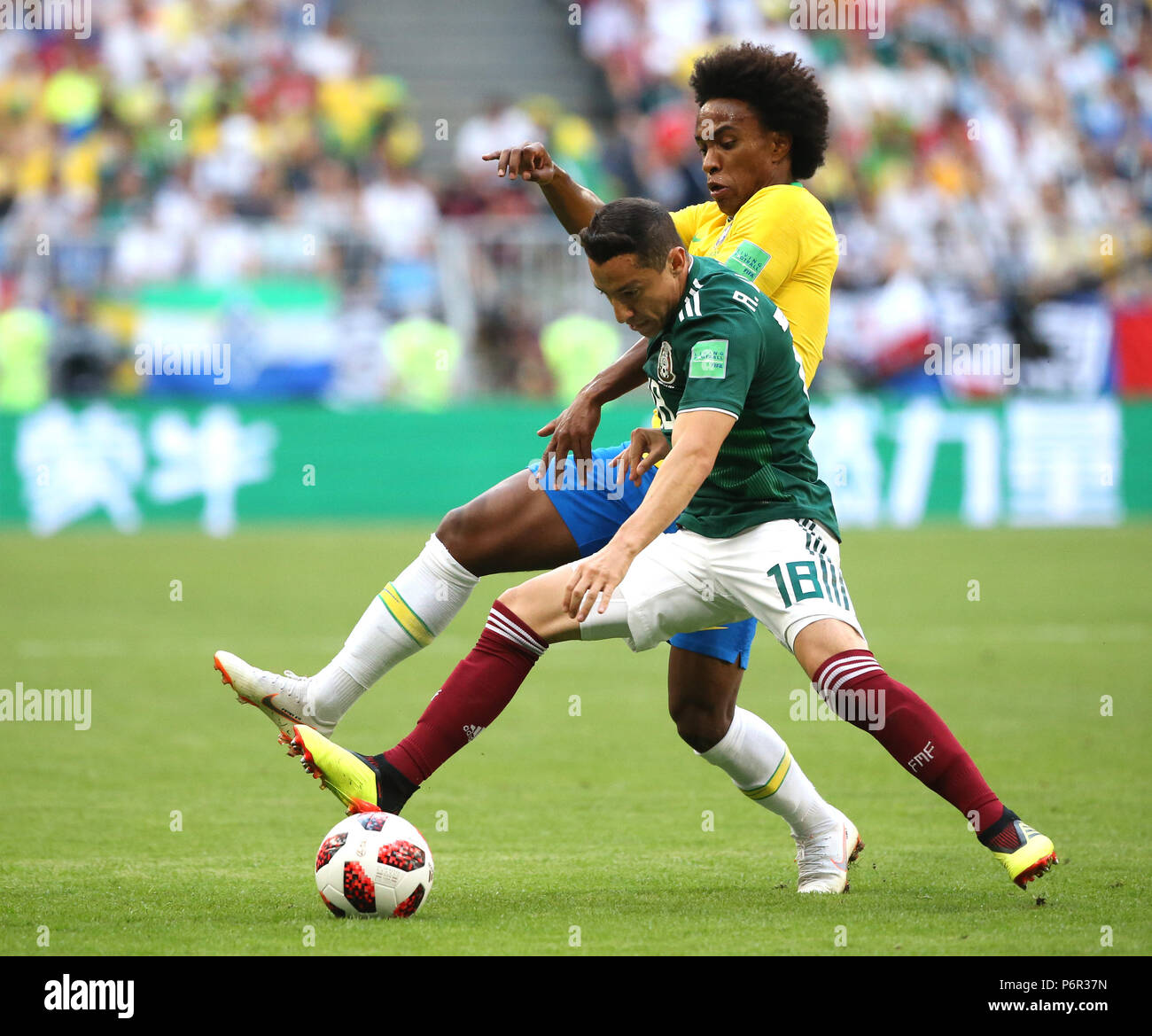 Samara, Russia. 2nd July, 2018. Willian (top) of Brazil vies with Andres Guardado of Mexico during the 2018 FIFA World Cup round of 16 match between Brazil and Mexico in Samara, Russia, July 2, 2018. Credit: Li Ming/Xinhua/Alamy Live News Stock Photo
