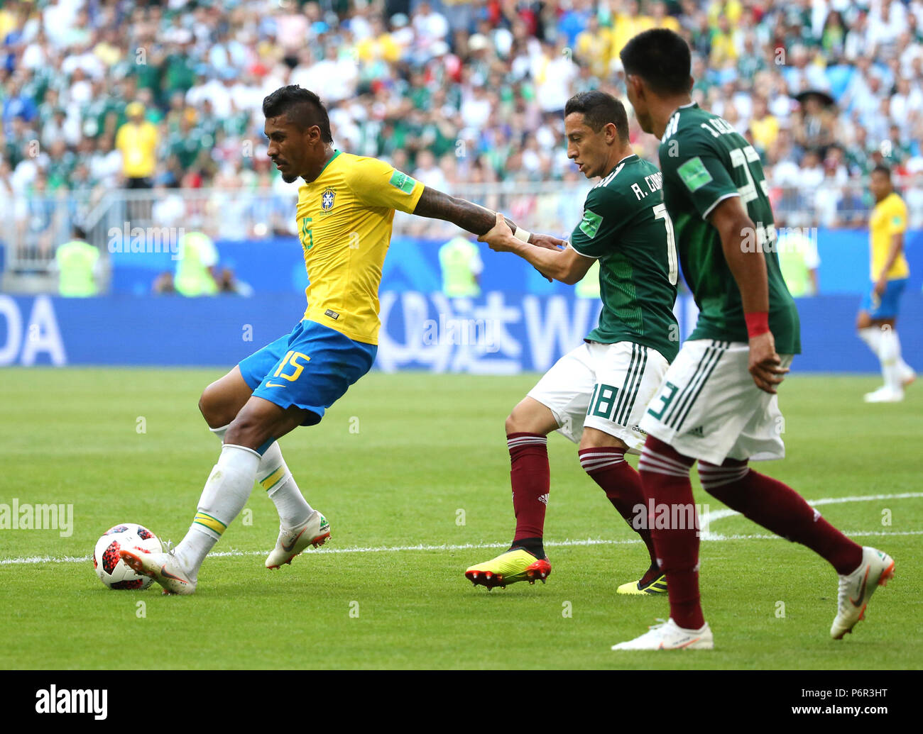 Samara, Russia. 2nd July, 2018. Paulinho (L) of Brazil vies with Andres Guardado (C) of Mexico during the 2018 FIFA World Cup round of 16 match between Brazil and Mexico in Samara, Russia, July 2, 2018. Credit: Li Ming/Xinhua/Alamy Live News Stock Photo