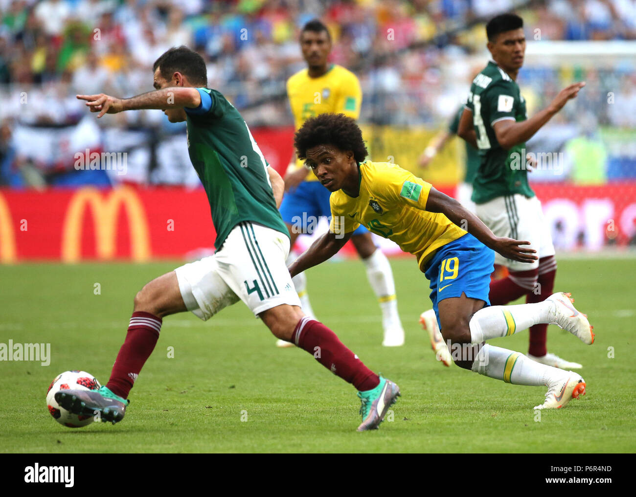 Samara, Russia. 2nd July, 2018. Willian (R front) of Brazil vies with Rafael Marquez (L front) of Mexico during the 2018 FIFA World Cup round of 16 match between Brazil and Mexico in Samara, Russia, July 2, 2018. Credit: Li Ming/Xinhua/Alamy Live News Stock Photo
