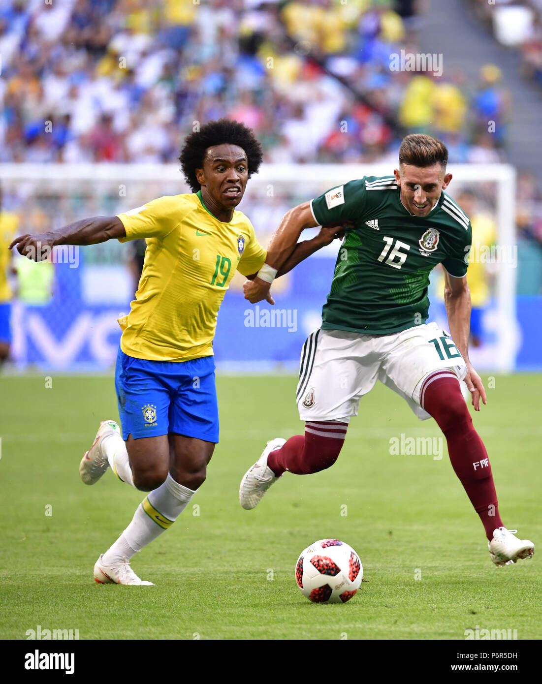 Samara, Russia. 2nd July, 2018. Willian (L) of Brazil vies with Hector Herrera of Mexico during the 2018 FIFA World Cup round of 16 match between Brazil and Mexico in Samara, Russia, July 2, 2018. Credit: Chen Yichen/Xinhua/Alamy Live News Stock Photo