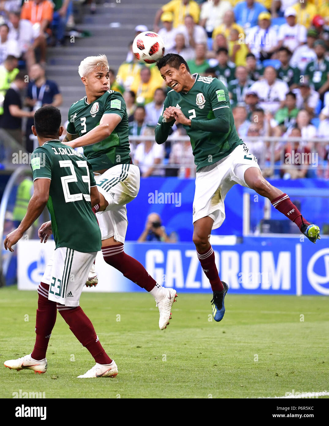 Samara, Russia. 2nd July, 2018. Mexico's Carlos Salcedo (C) and Hugo Ayala (R) compete during the 2018 FIFA World Cup round of 16 match between Brazil and Mexico in Samara, Russia, July 2, 2018. Credit: Chen Yichen/Xinhua/Alamy Live News Stock Photo