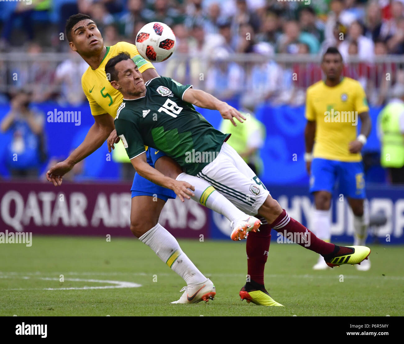 Samara, Russia. 2nd July, 2018. Casemiro (top) of Brazil vies with Andres Guardado of Mexico during the 2018 FIFA World Cup round of 16 match between Brazil and Mexico in Samara, Russia, July 2, 2018. Brazil won 2-0 and advanced to the quarter-final. Credit: Chen Yichen/Xinhua/Alamy Live News Stock Photo