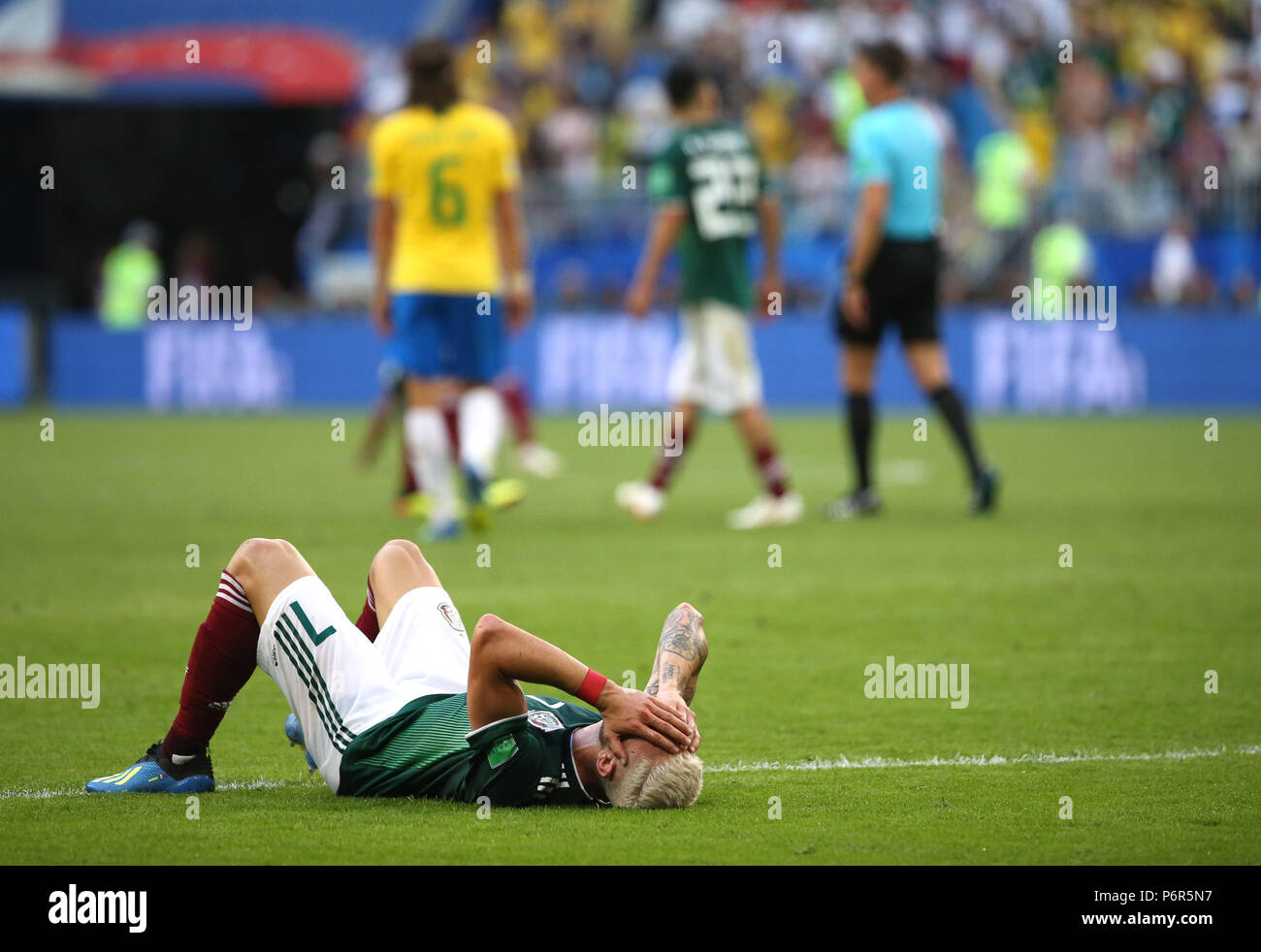 Samara, Russia. 2nd July, 2018. Miguel Layun (bottom) of Mexico lies on the pitch after the 2018 FIFA World Cup round of 16 match between Brazil and Mexico in Samara, Russia, July 2, 2018. Brazil won 2-0 and advanced to the quarter-final. Credit: Li Ming/Xinhua/Alamy Live News Stock Photo