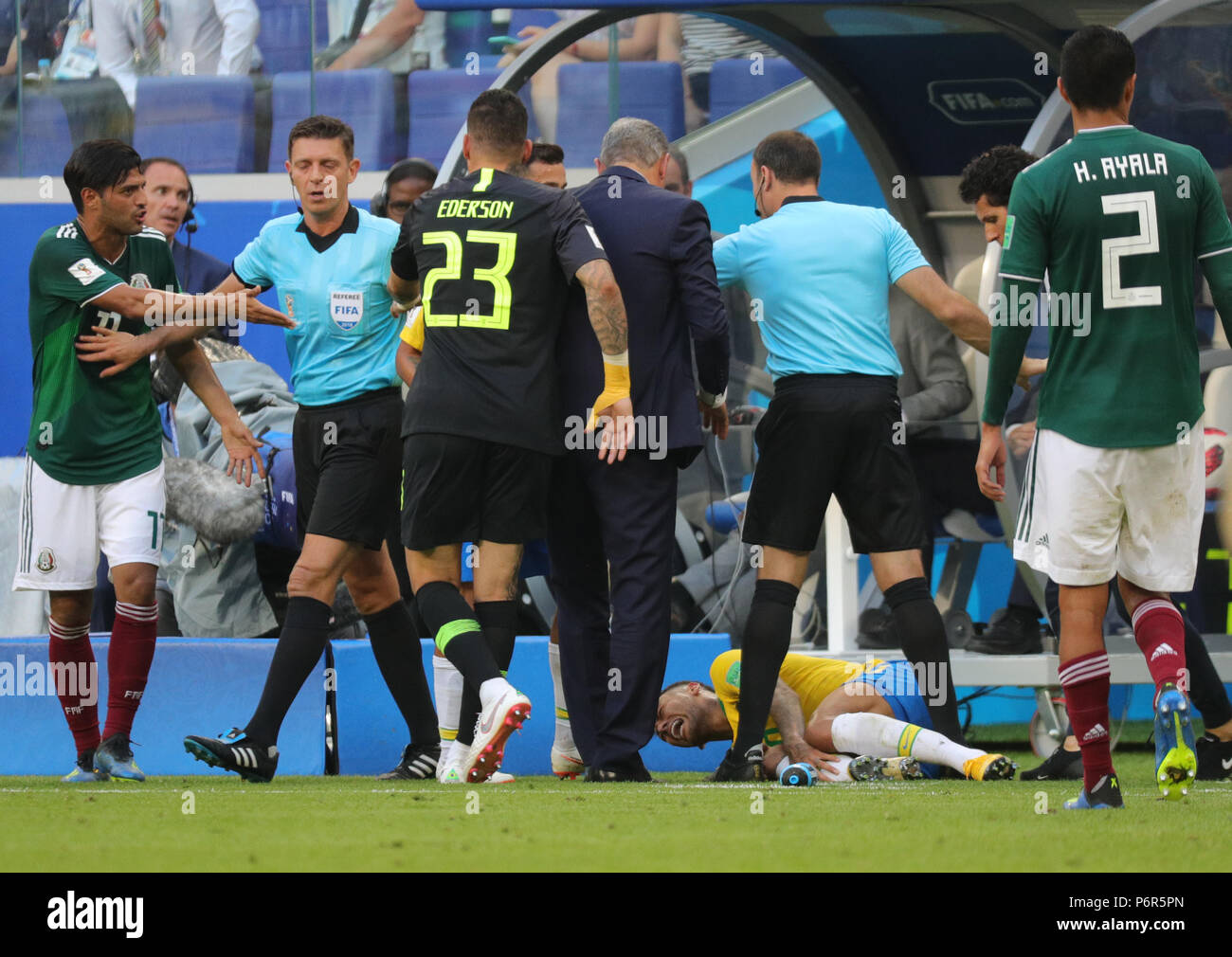 Samara, Russia. 02nd July, 2018. Soccer, World Cup 2018, Final round - round of 16: Mexico vs. Brazil at the Samara stadium: Brazil's Neymar lying injured on the floor after a foul while match referee from Italy Gianluca Rocchi (2nd from left) walks between the players. Credit: Christian Charisius/dpa/Alamy Live News Stock Photo